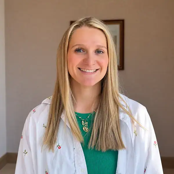 Professional speech therapist in Montana smiling at the camera, promoting speech therapy services for children and adults.